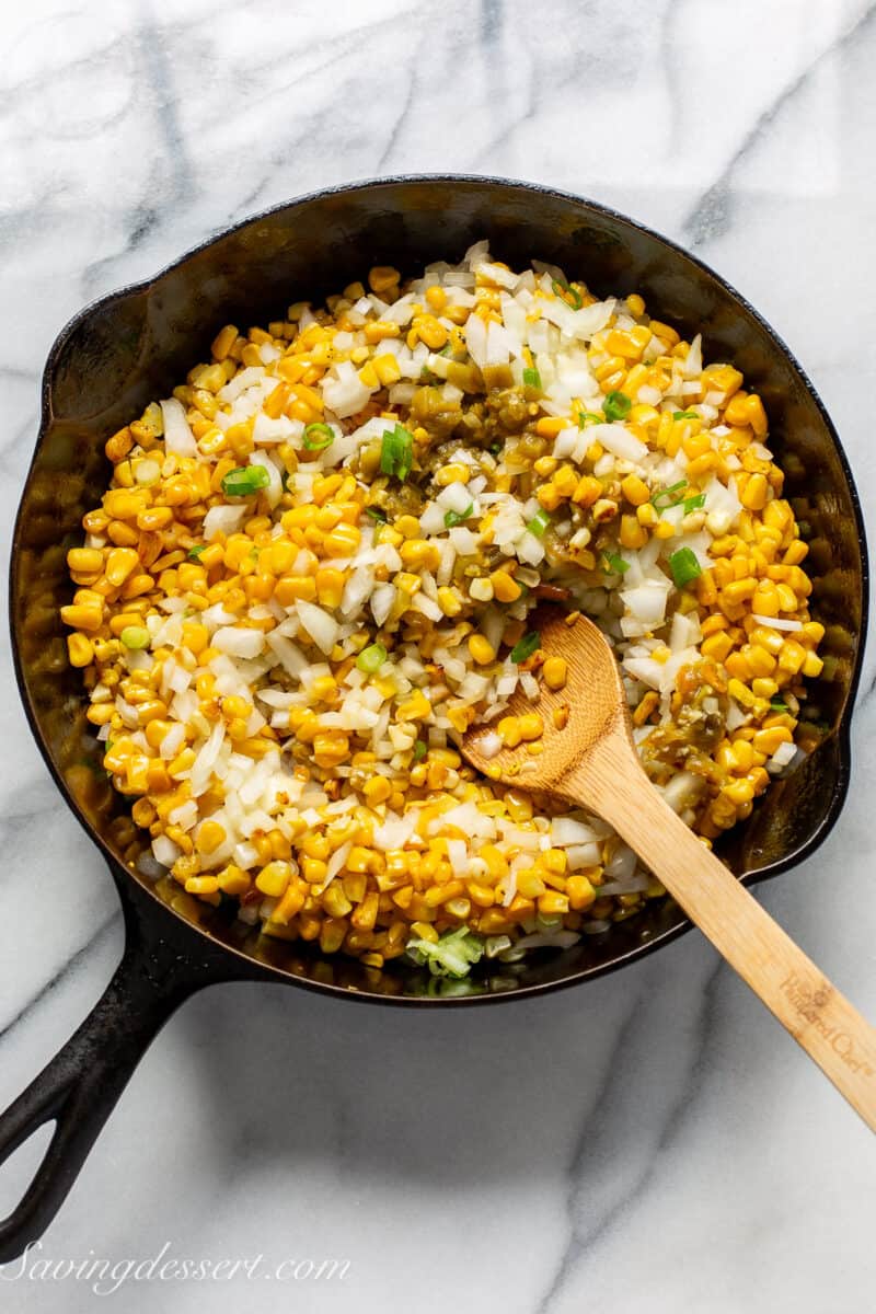 a skillet with corn and onions