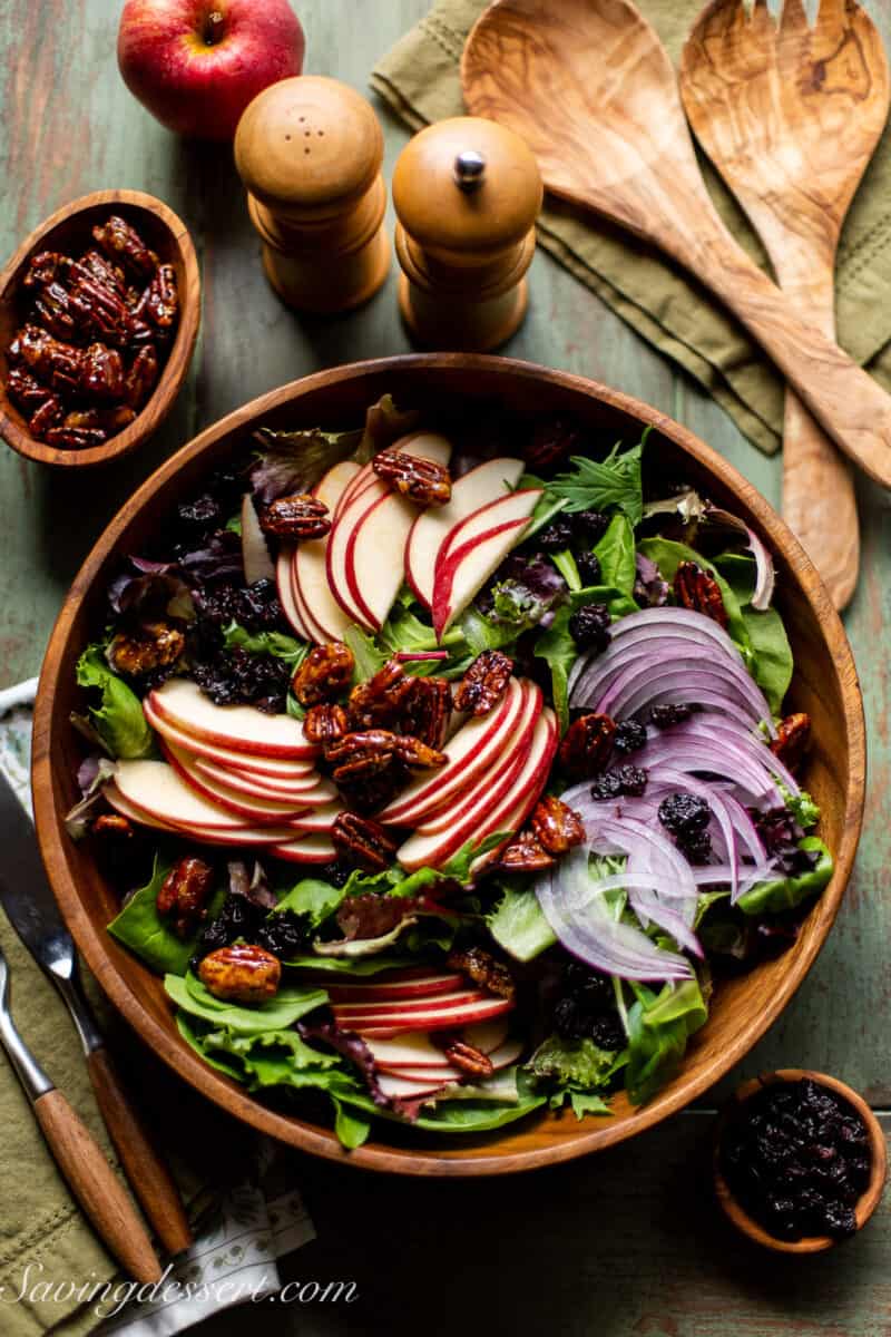 An overhead view of a wooden bowl filled with apple salad.