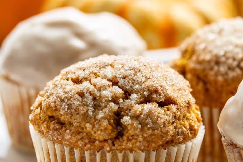 Closeup photo of a pumpkin muffin topped with coarse sugar