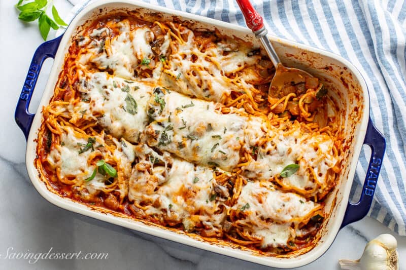 Overhead view of a casserole pan filled with cheesy baked spaghetti.