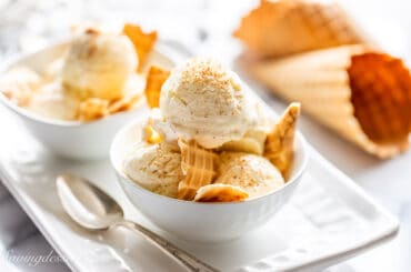 A bowl of eggnog ice cream with shards of ice cream cones sprinkled in the bowl.