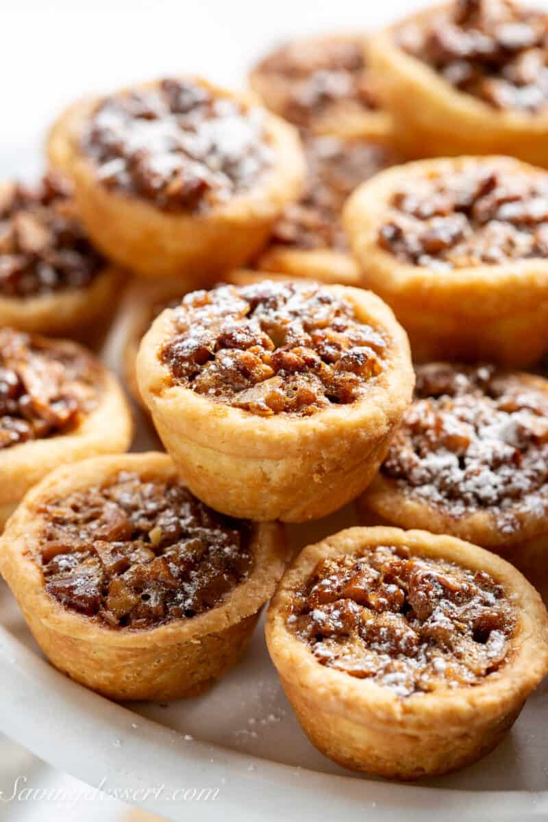 Pecan tassies on a cake stand.