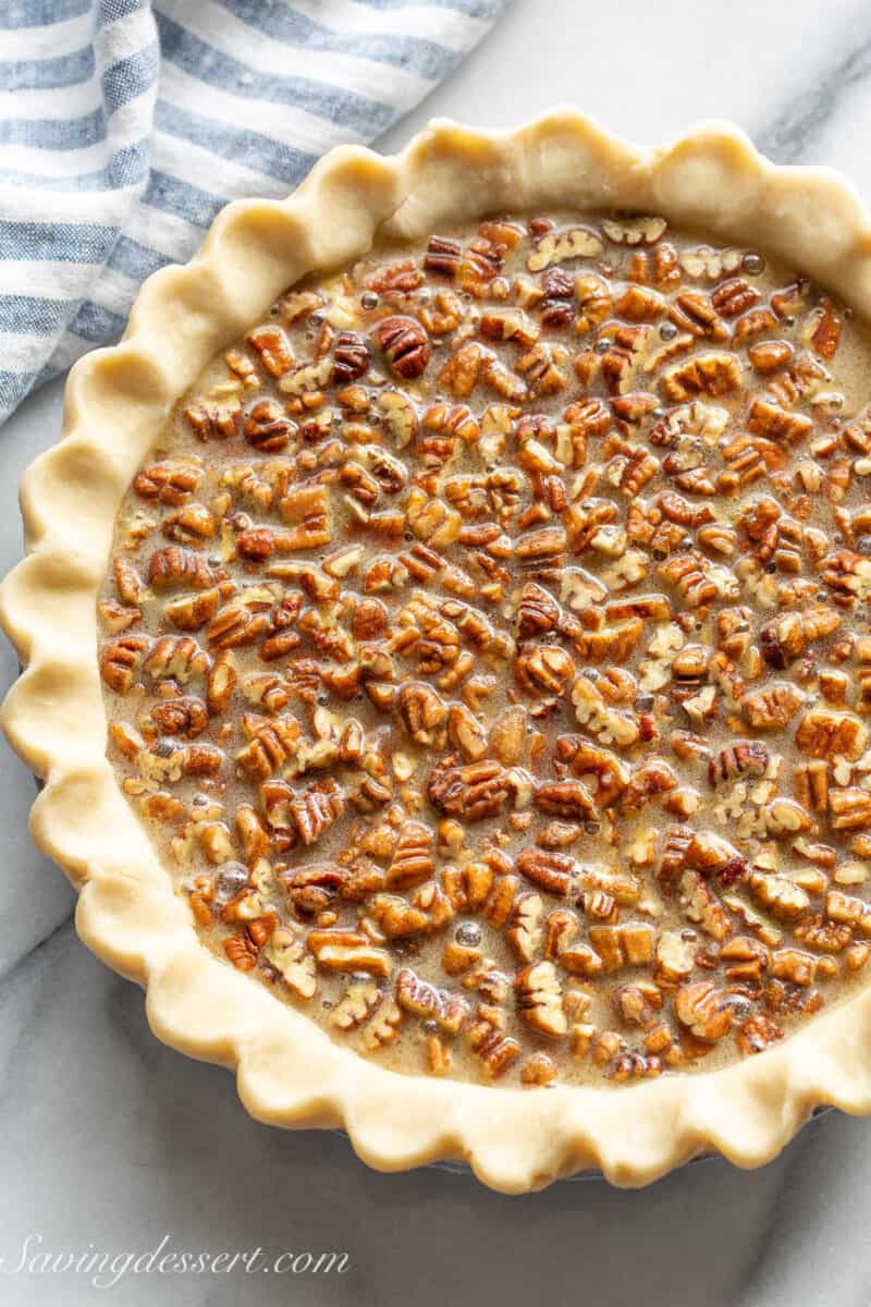 An overhead view of an unbaked pecan pie ready to go in the oven.