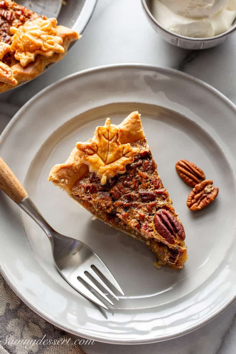 An overhead view of a slice of pecan pie with a fork.