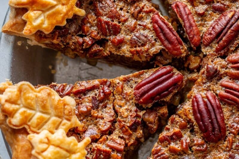 An overhead view of a sliced pecan pie.