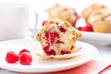 A closeup of the inside of a raspberry muffin on a plate.