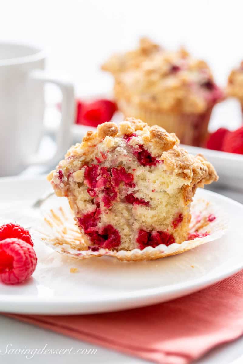 A closeup of the inside of a raspberry muffin on a plate.