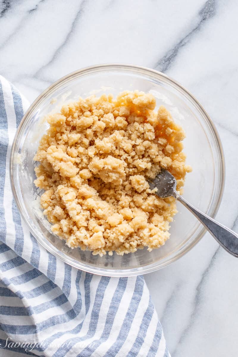 A buttery streusel crumble topping ready to be scooped on muffin batter.