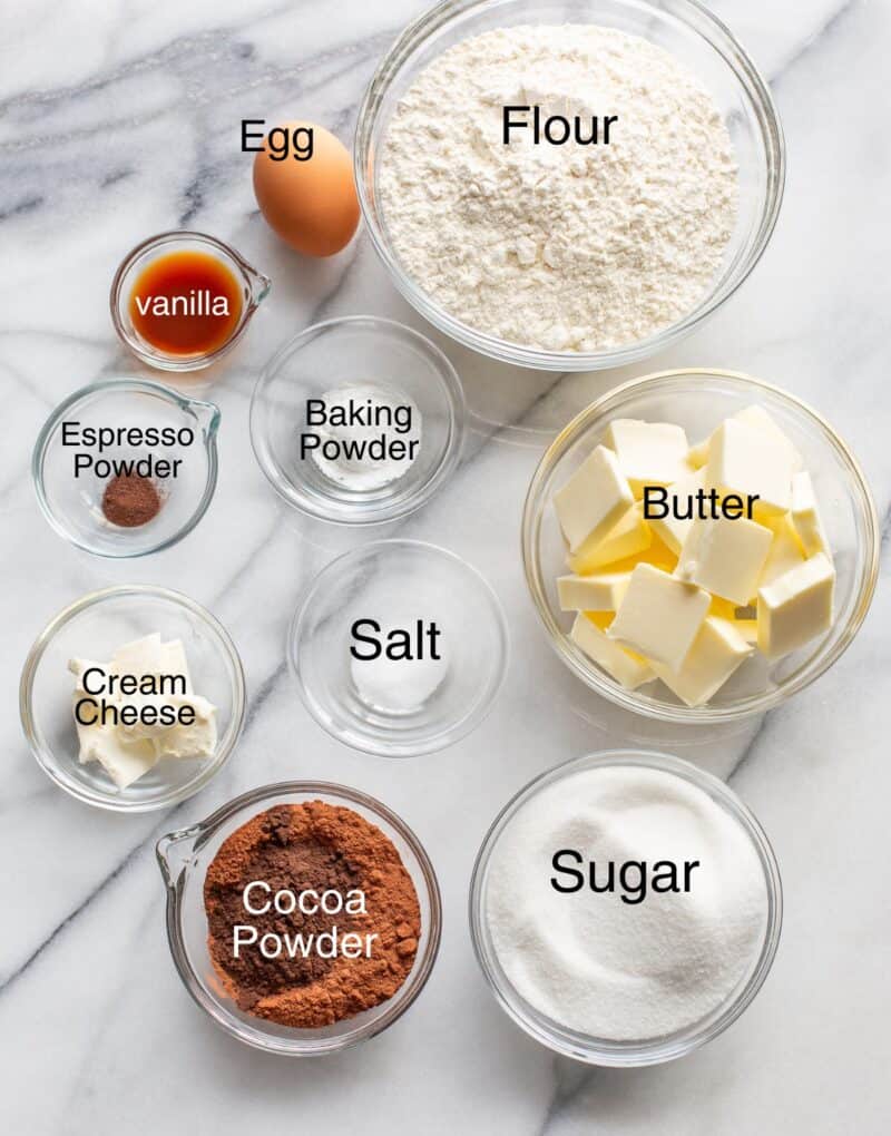 An overhead photo showing a collage of ingredients needed to make chocolate heart shaped Valentine's Day cookies.