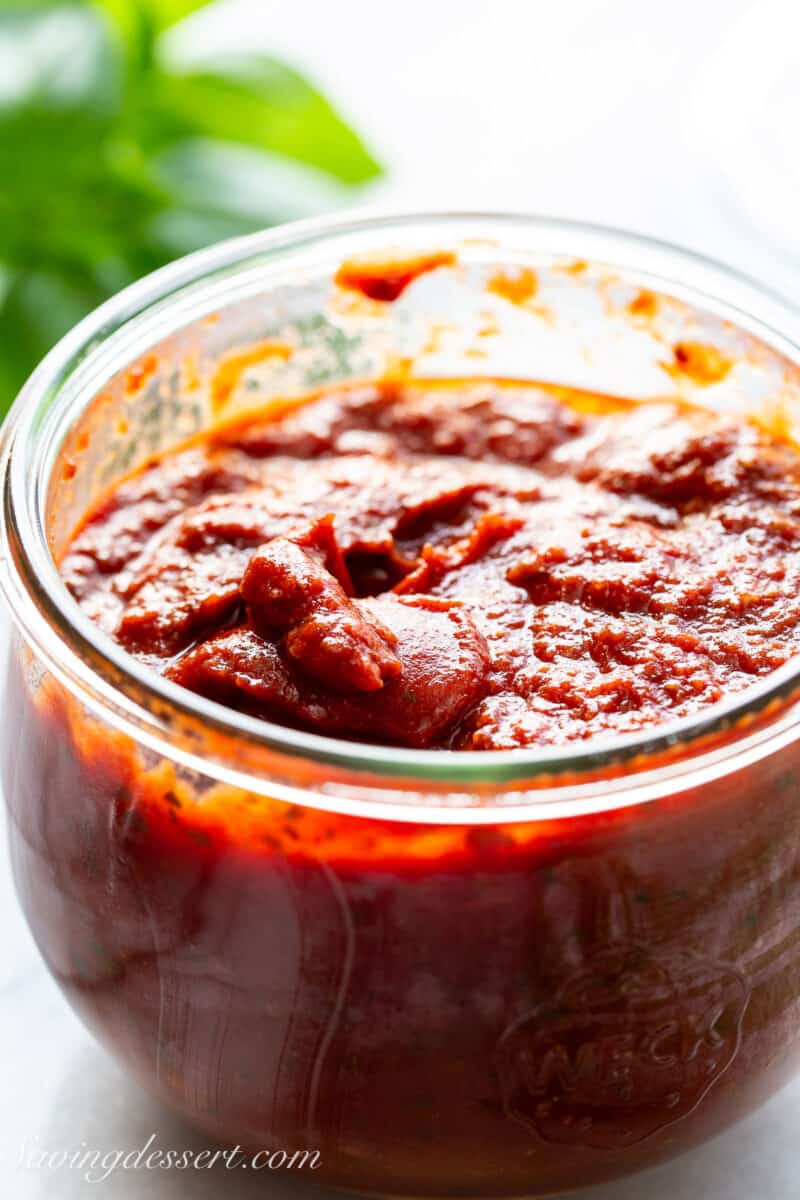 A closeup of a jar of pizza sauce.