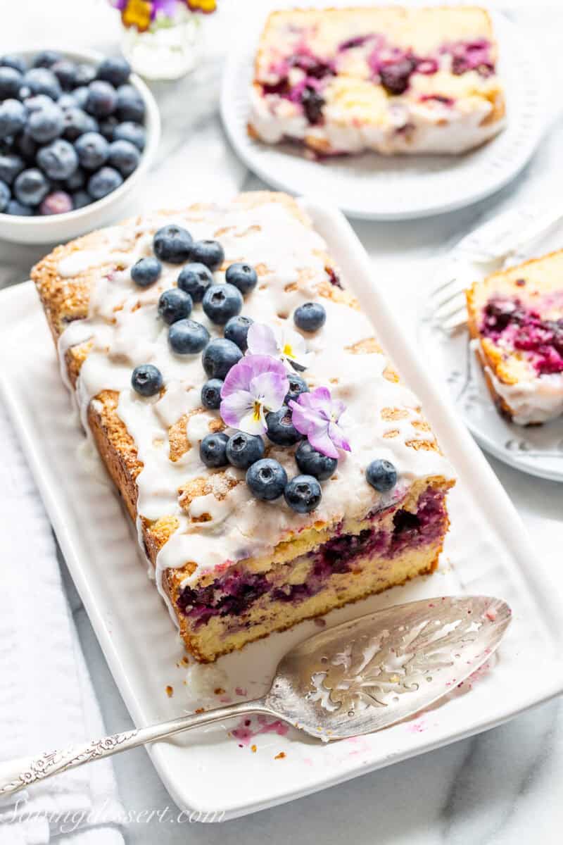 A sliced blueberry lemon loaf on a platter.