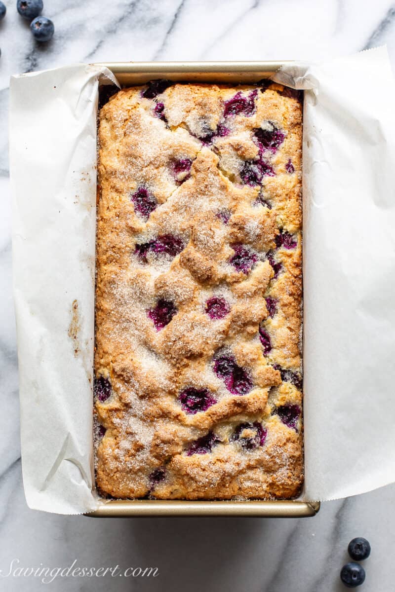 Blueberry lemon bread fresh from the oven in a loaf pan.