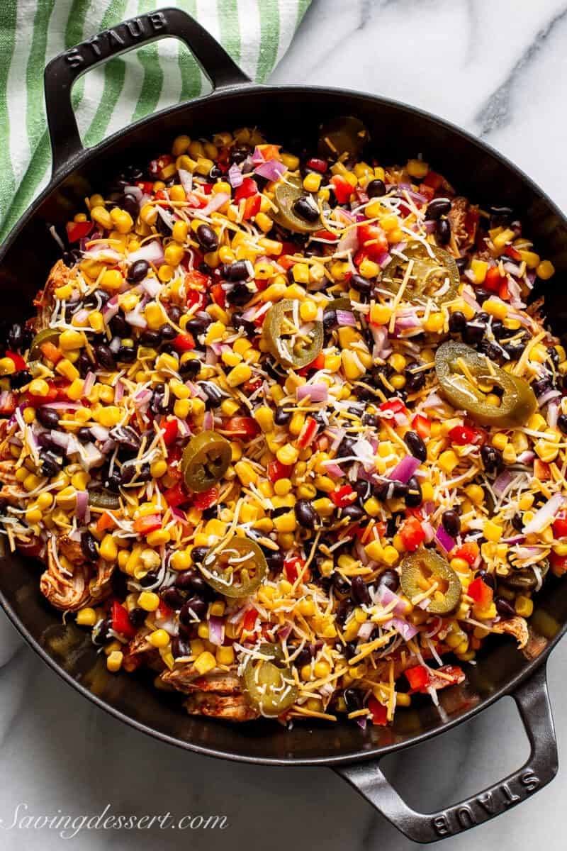 A layered casserole with black beans, corn and cheese.