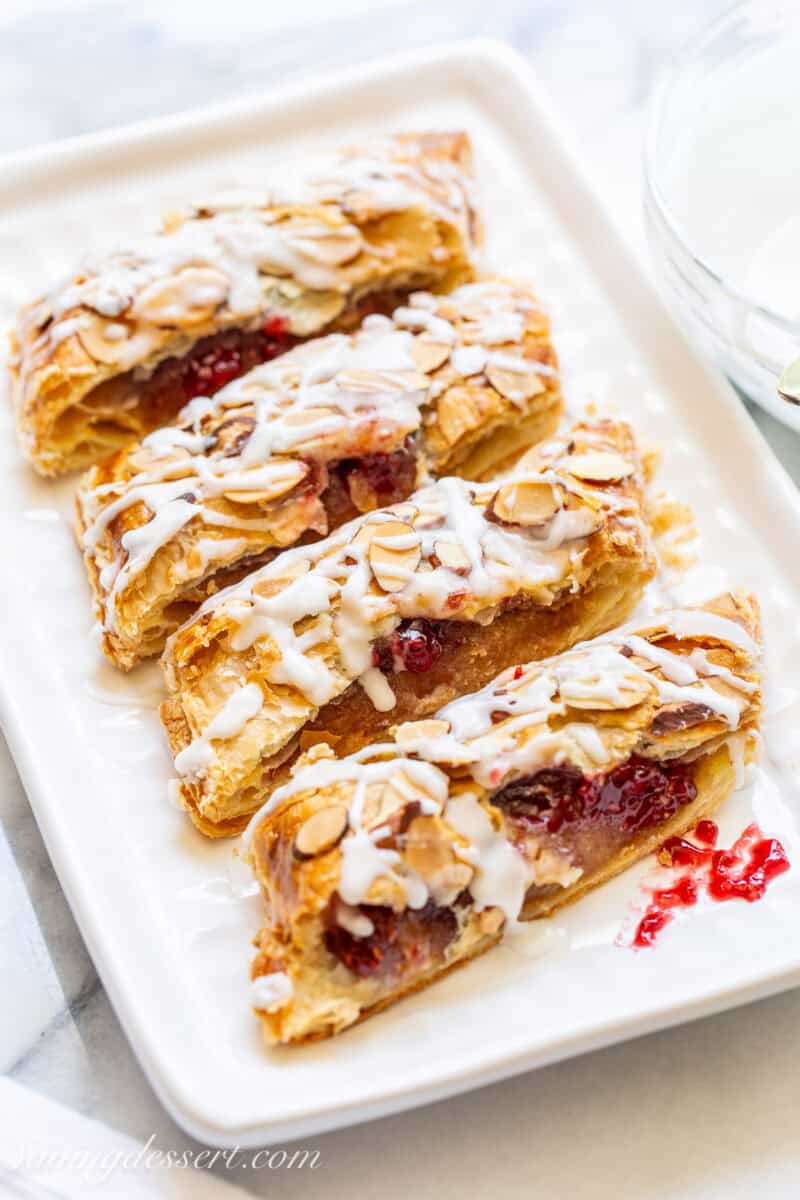 A side view of a small platter filled with sliced raspberry pastries.