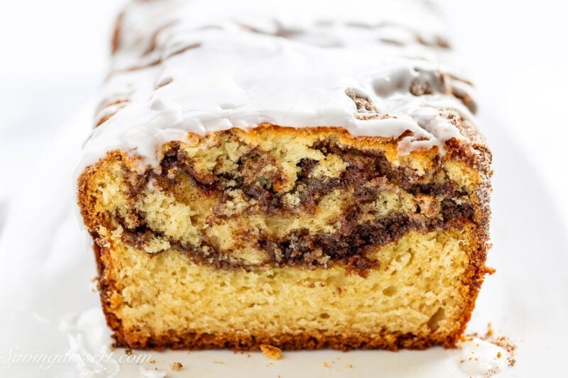 A closeup of a sliced loaf of cinnamon swirl quick bread.