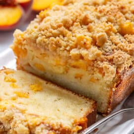 A sliced peach pound cake on a platter.