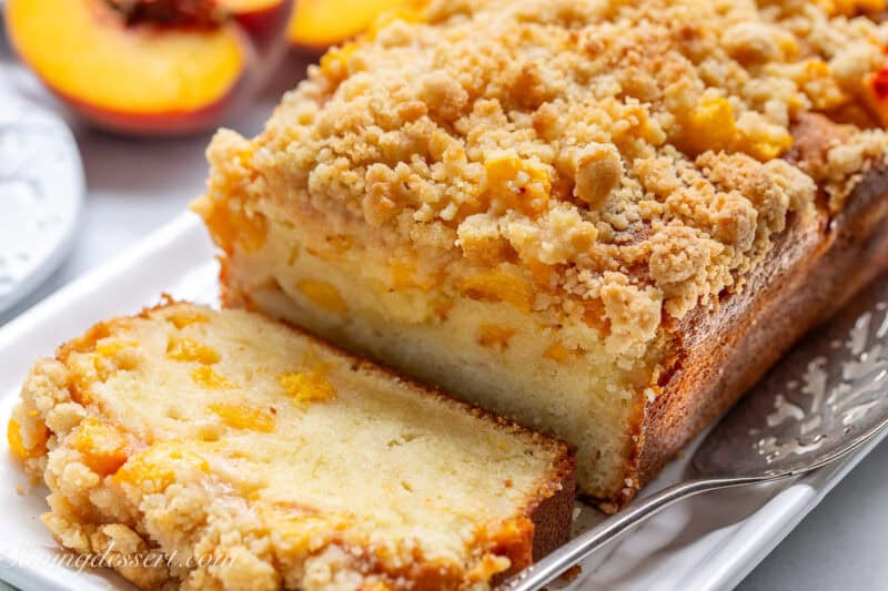 A sliced peach pound cake on a platter.