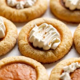 A pumpkin pie cookies topped with a swirl of cool whip.