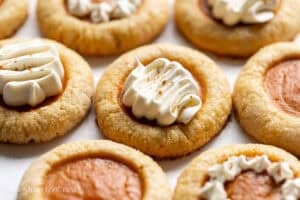 A pumpkin pie cookies topped with a swirl of cool whip.