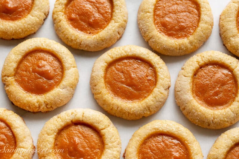 A closeup shot of spiced cookies filled with a pumpkin pie filling.