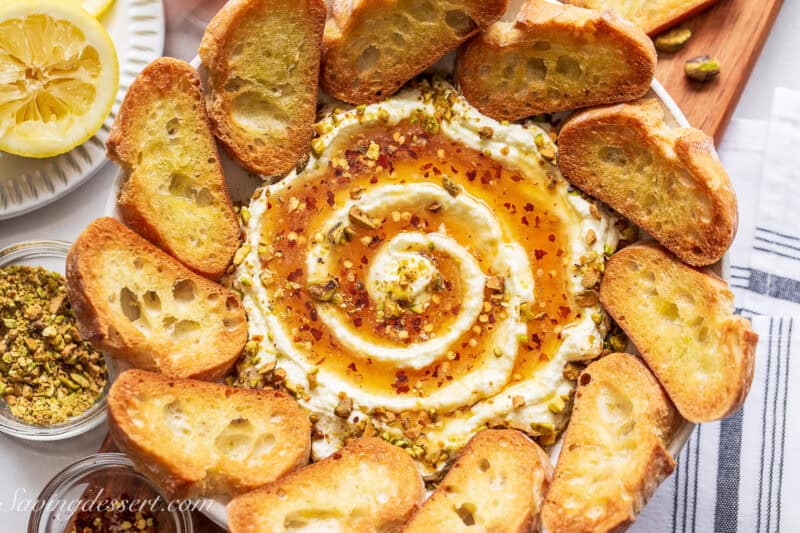 A bowl of whipped feta dip with toast for serving.