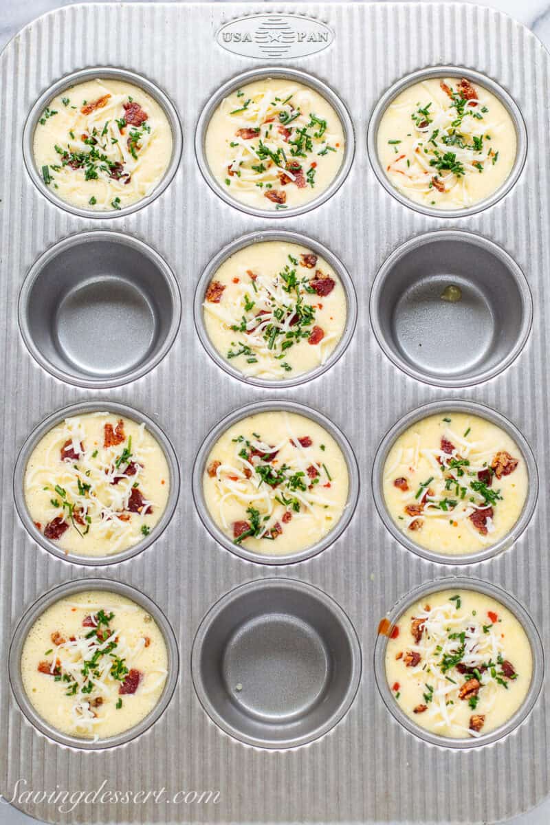 Egg muffin batter in a muffin tin ready to go in the oven.