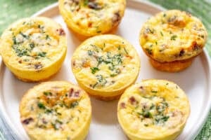 An overhead picture of six egg muffins on a small plate.
