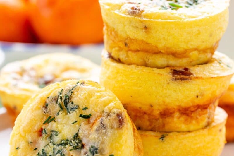A stack of egg muffins on a plate with orange sections.