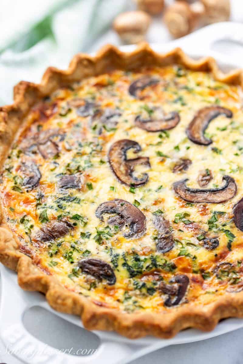 A baked spinach quiche with a golden brown crust.