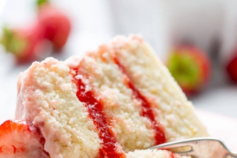 A closeup of a slice of lemon strawberry cake.