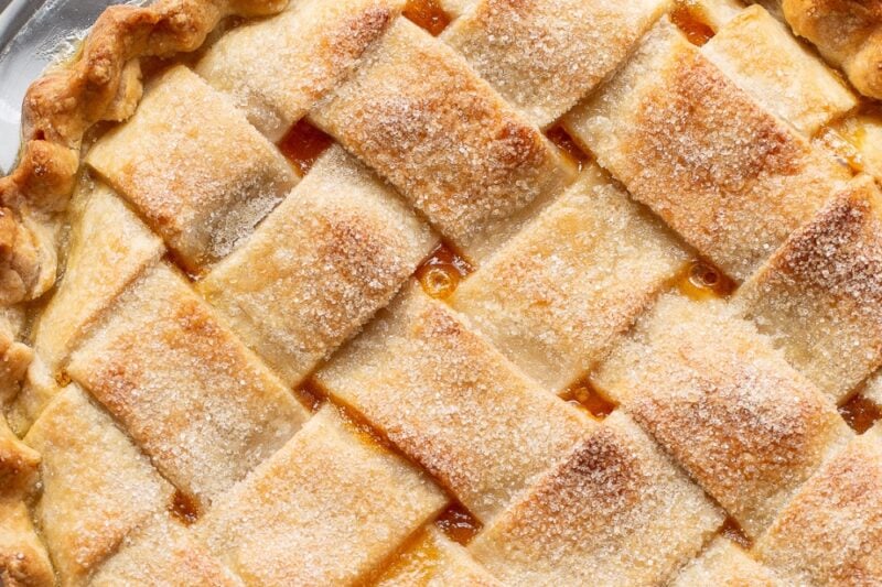 A whole lattice top apricot pie fresh from the oven.