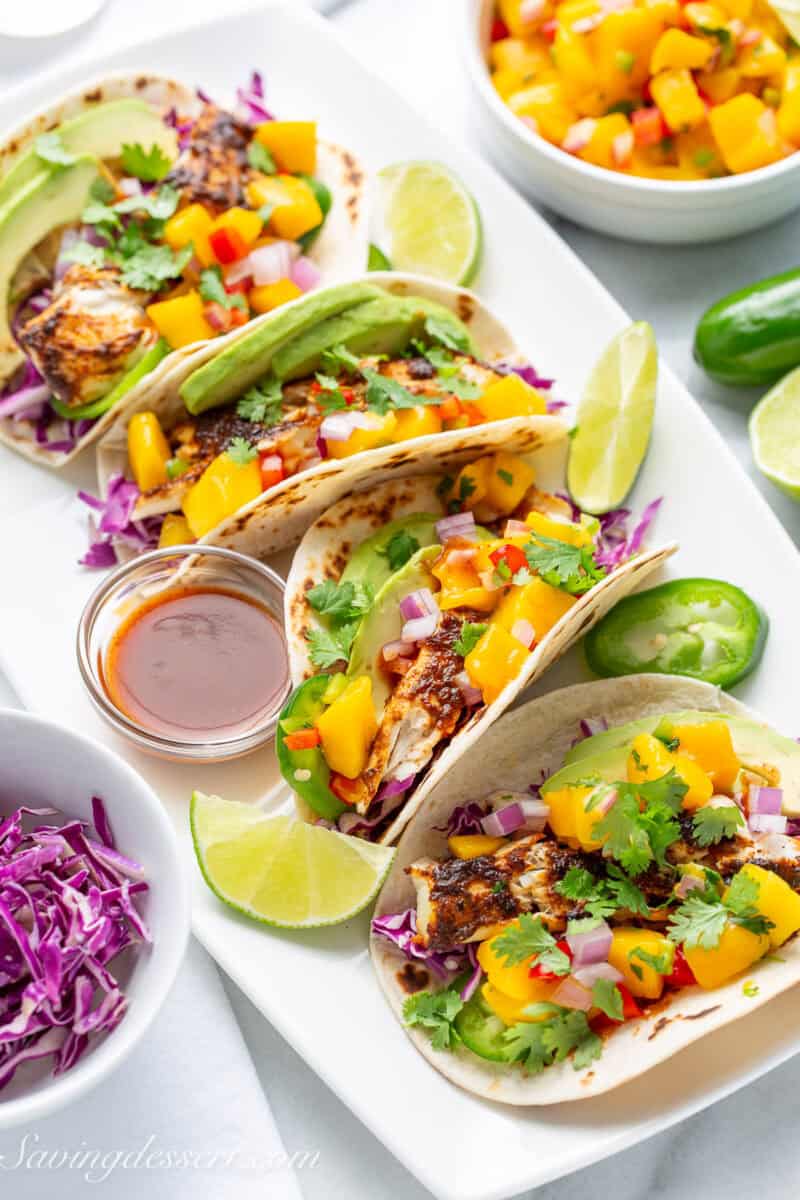 Fish tacos with limes, cabbage and mango salsa.