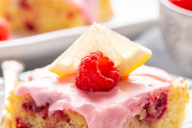 A lemon raspberry blondies on a plate with a fork.