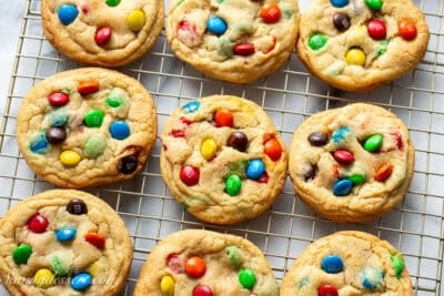 A wire rack with fresh baked M&M Cookies..