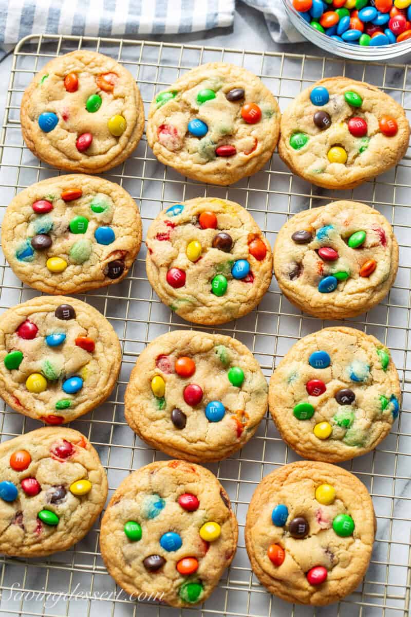 A wire cooling rack with M&M Cookies in three rows.