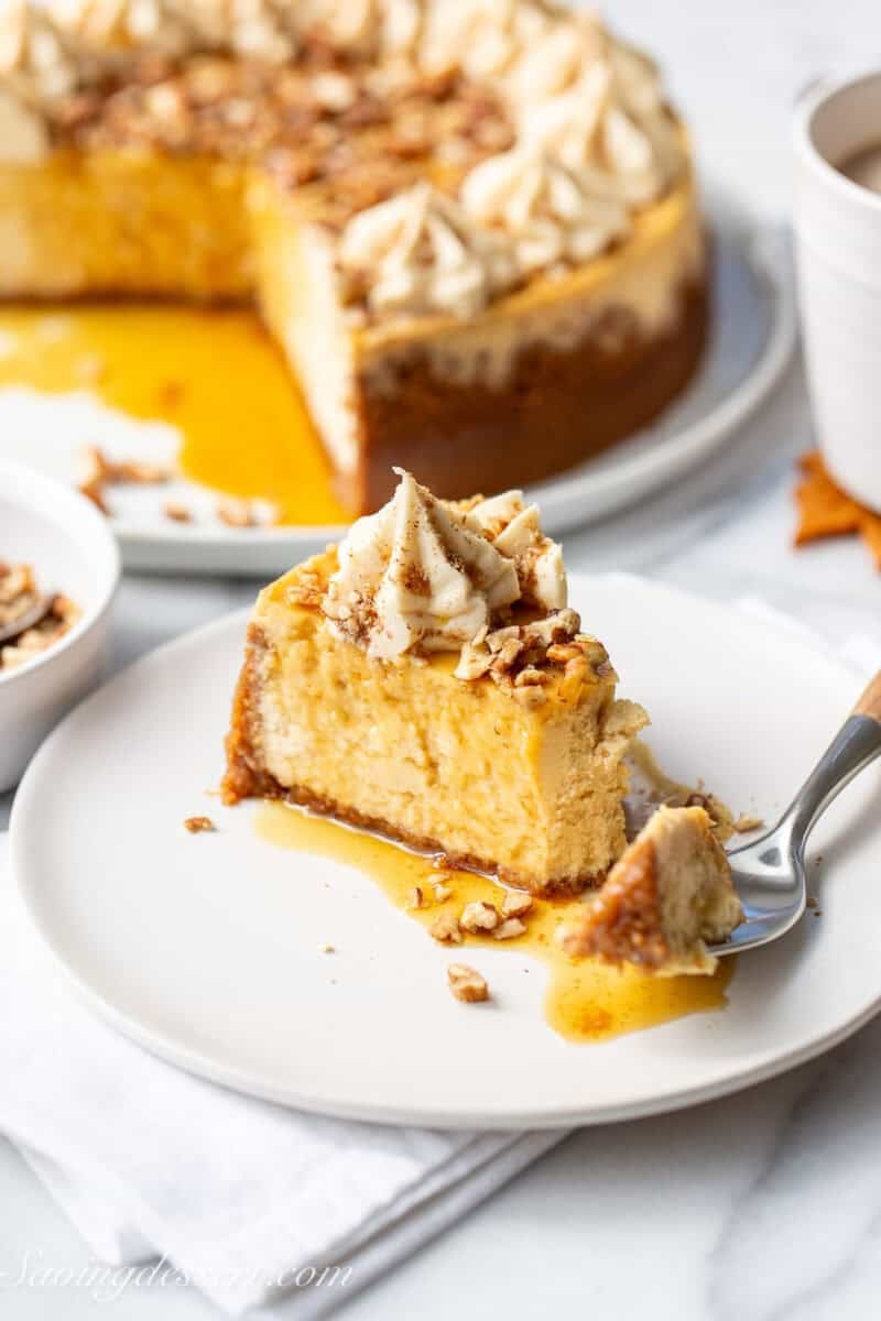 A slice of maple cheesecake with a fork cutting a corner piece off.