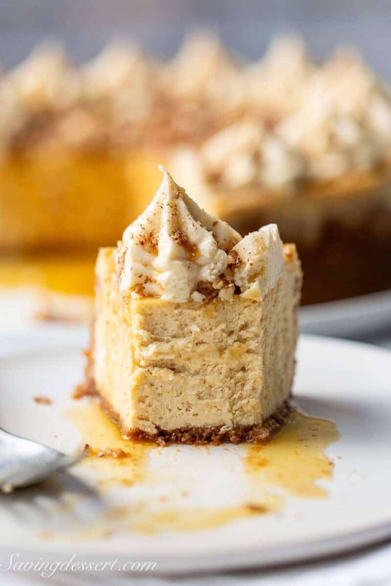 A partially eaten slice of maple cheesecake on a plate.