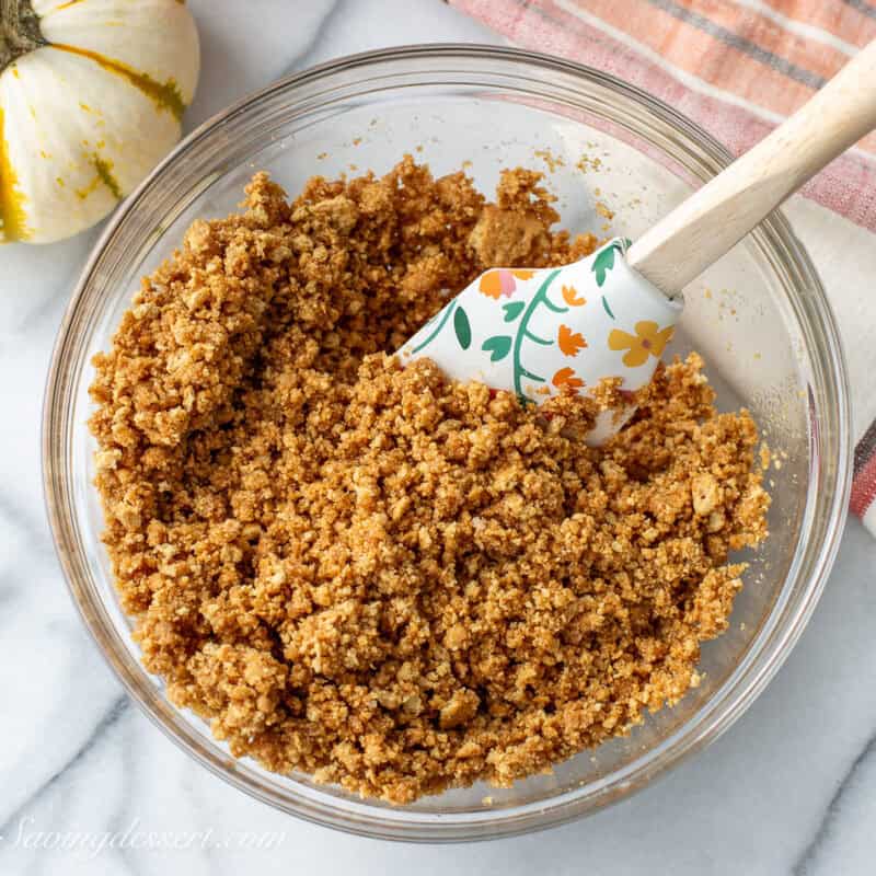 Graham cracker crust ingredients stirred together in a bowl.
