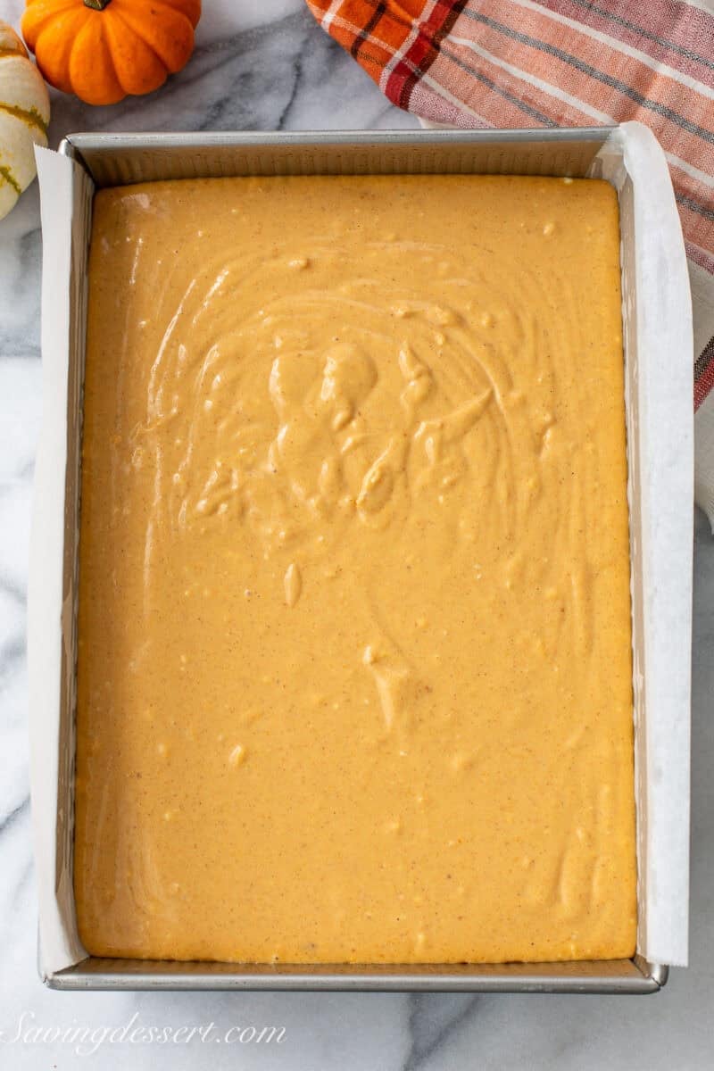 Pumpkin cheesecake batter in a pan ready to go in the oven.