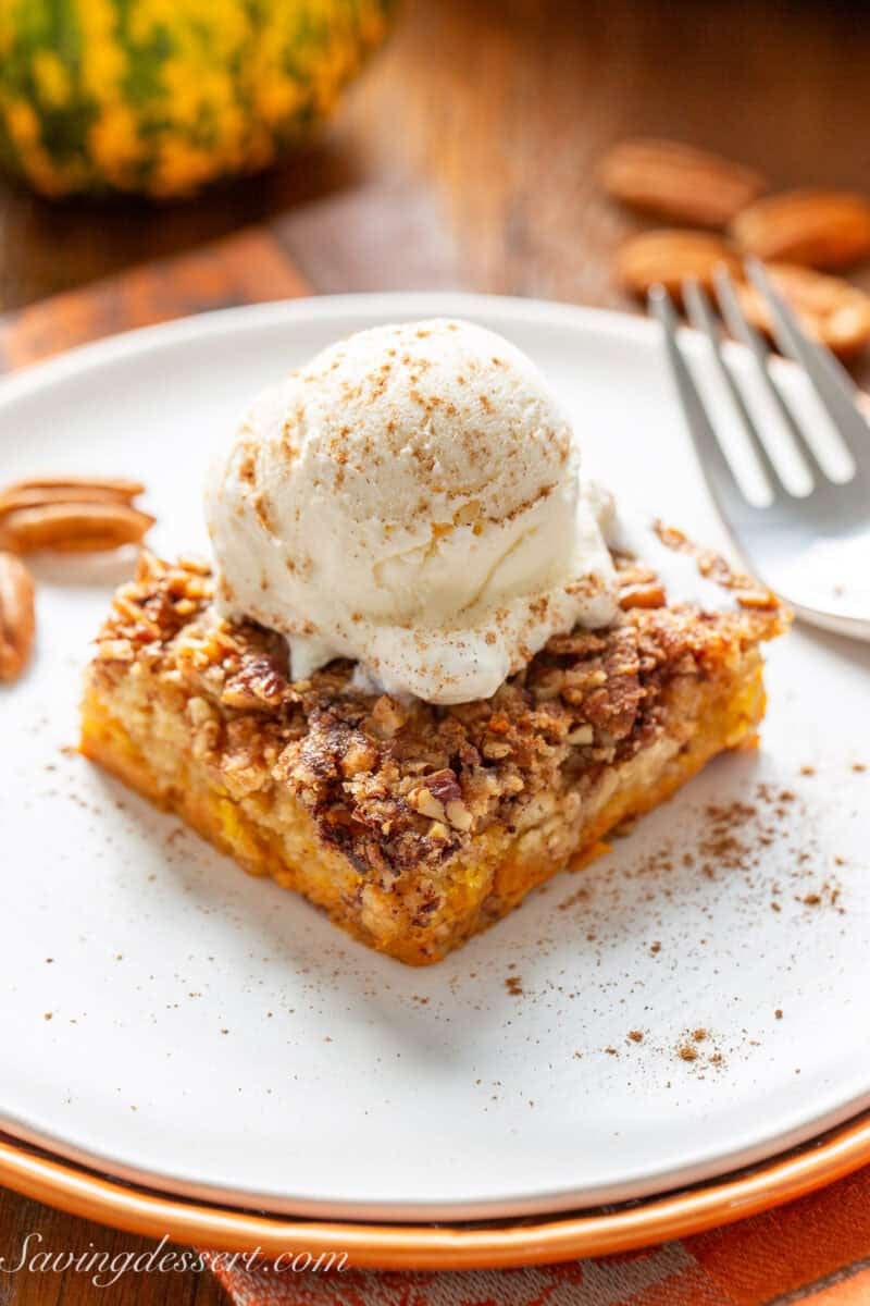 Pumpkin Dump Cake on a plate with a scoop of ice cream.