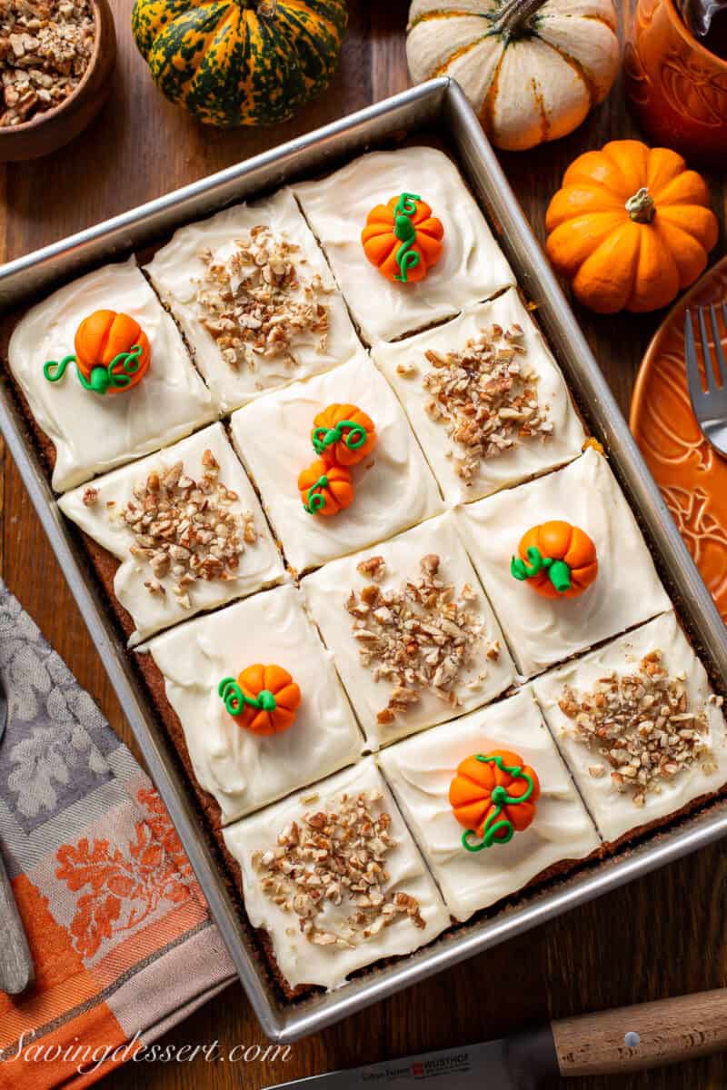 An overhead photo of a pan of pumpkin spice cake cut into 12 squares.