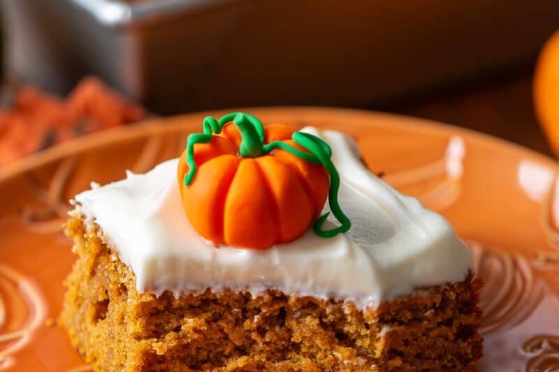 A closeup of a piece of pumpkin cake on a plate.