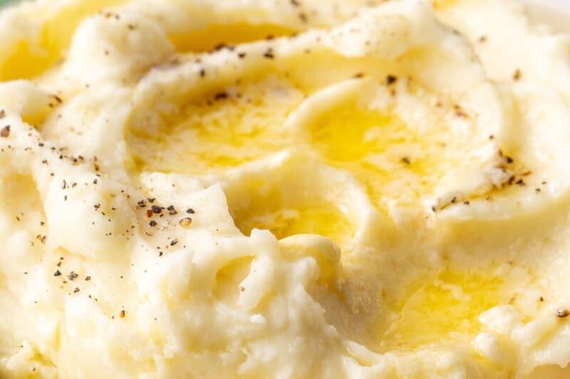A side view of a bowl of creamy mashed potatoes