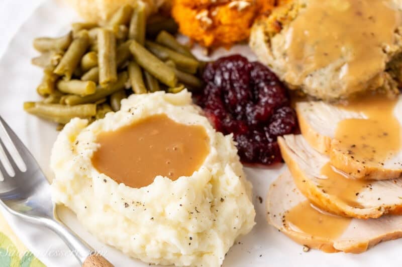 Potatoes, gravy and all the trimmings on a Thanksgiving plate.