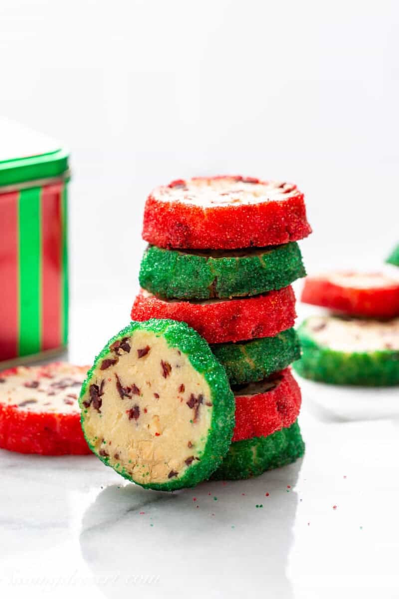 A stack of cranberry shortbread cookies with red and green sanding sugar on the edges.
