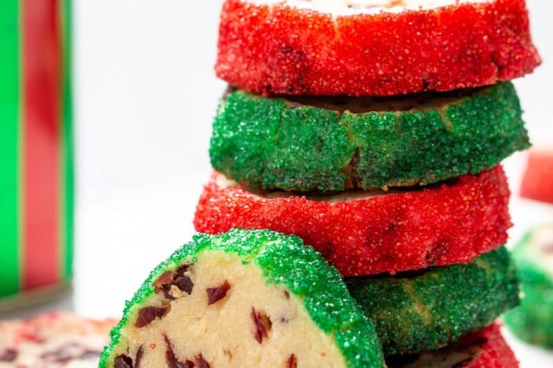 A stack of cranberry shortbread cookies with the edges rolled in red and green sanding sugar.