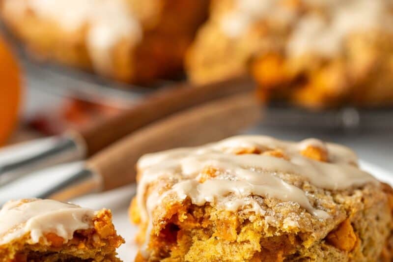 A pumpkin scone broken open on a plate.