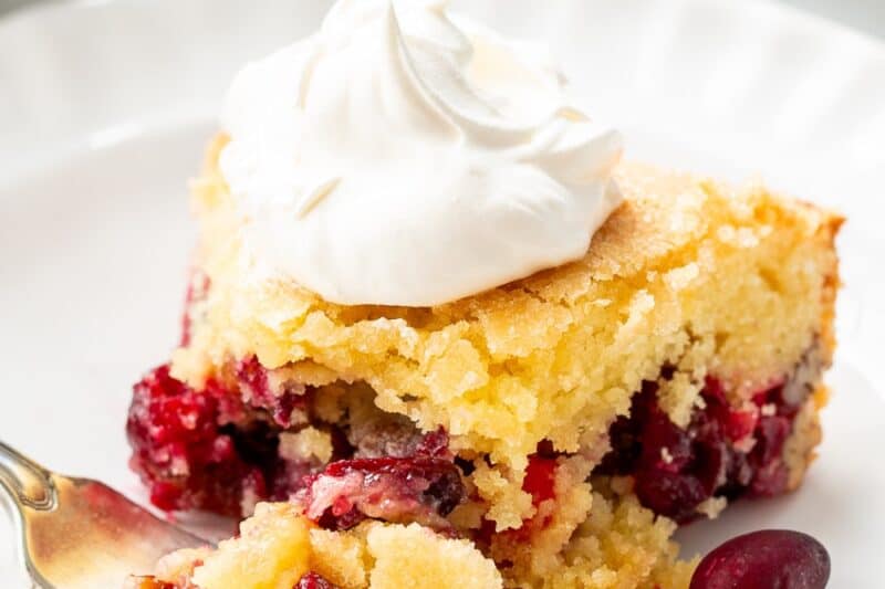 A partially eaten piece of nantucket pie with cranberries and pecans.