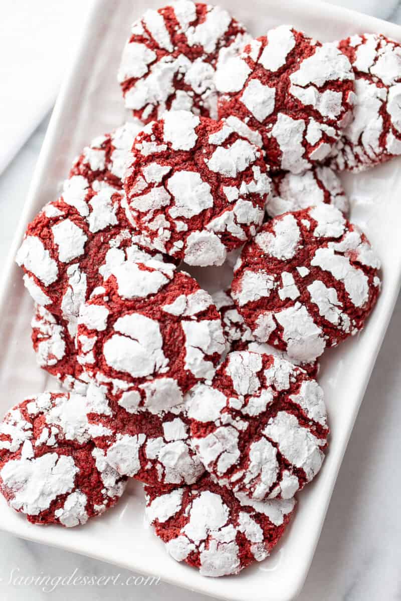 A closeup of a small plate of red velvet crinkle cookies.