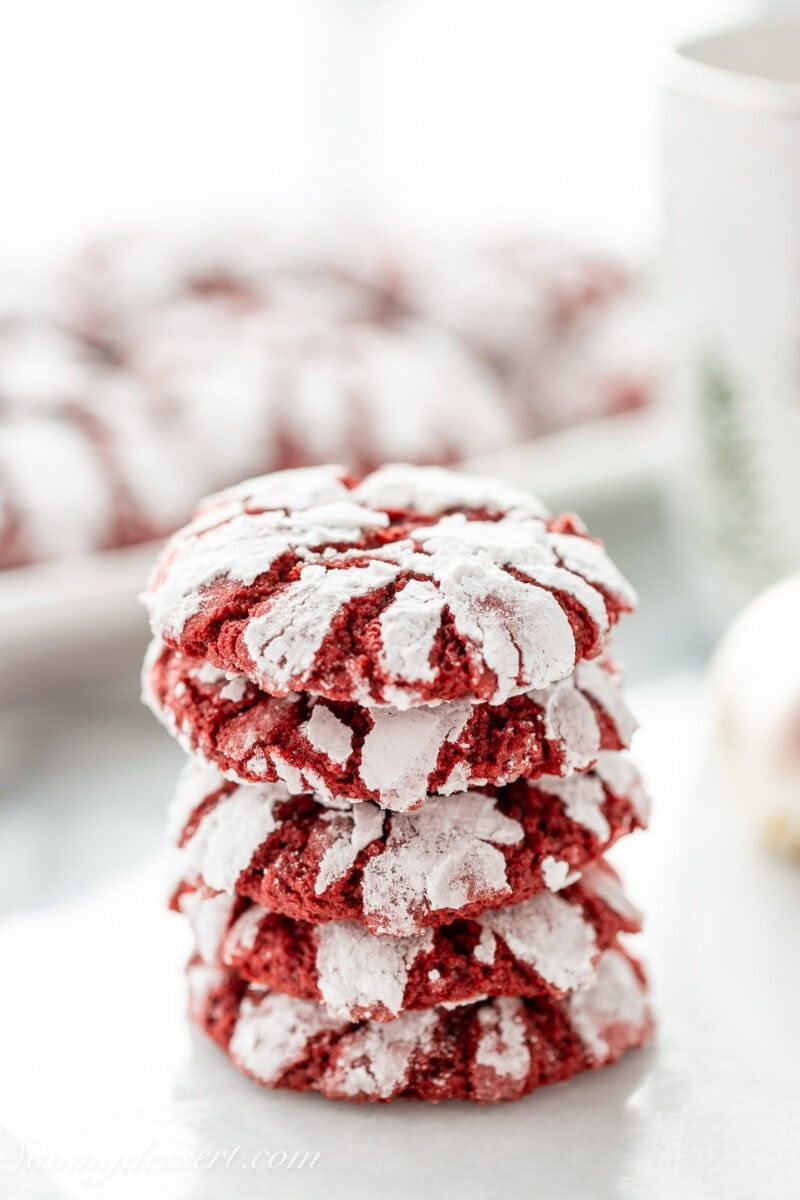 Red velvet crinkle cookies in a stack.